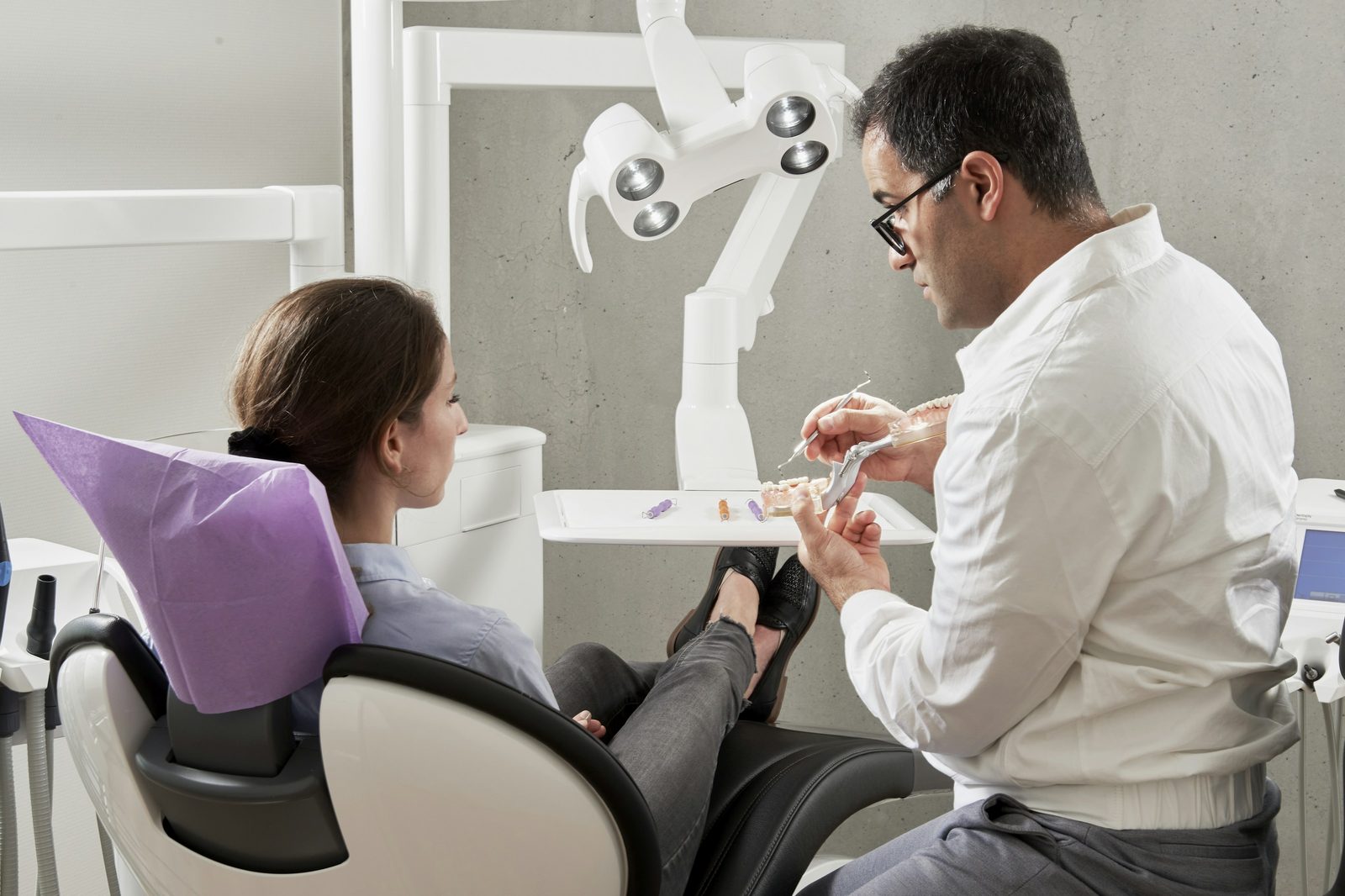 A Livora dentist carrying out a check-up on a patient in the treatment room